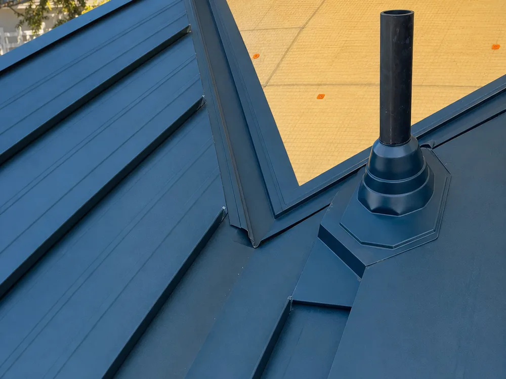 Properly installed metal roof valley flashing, underlayment, and vent penetration details
